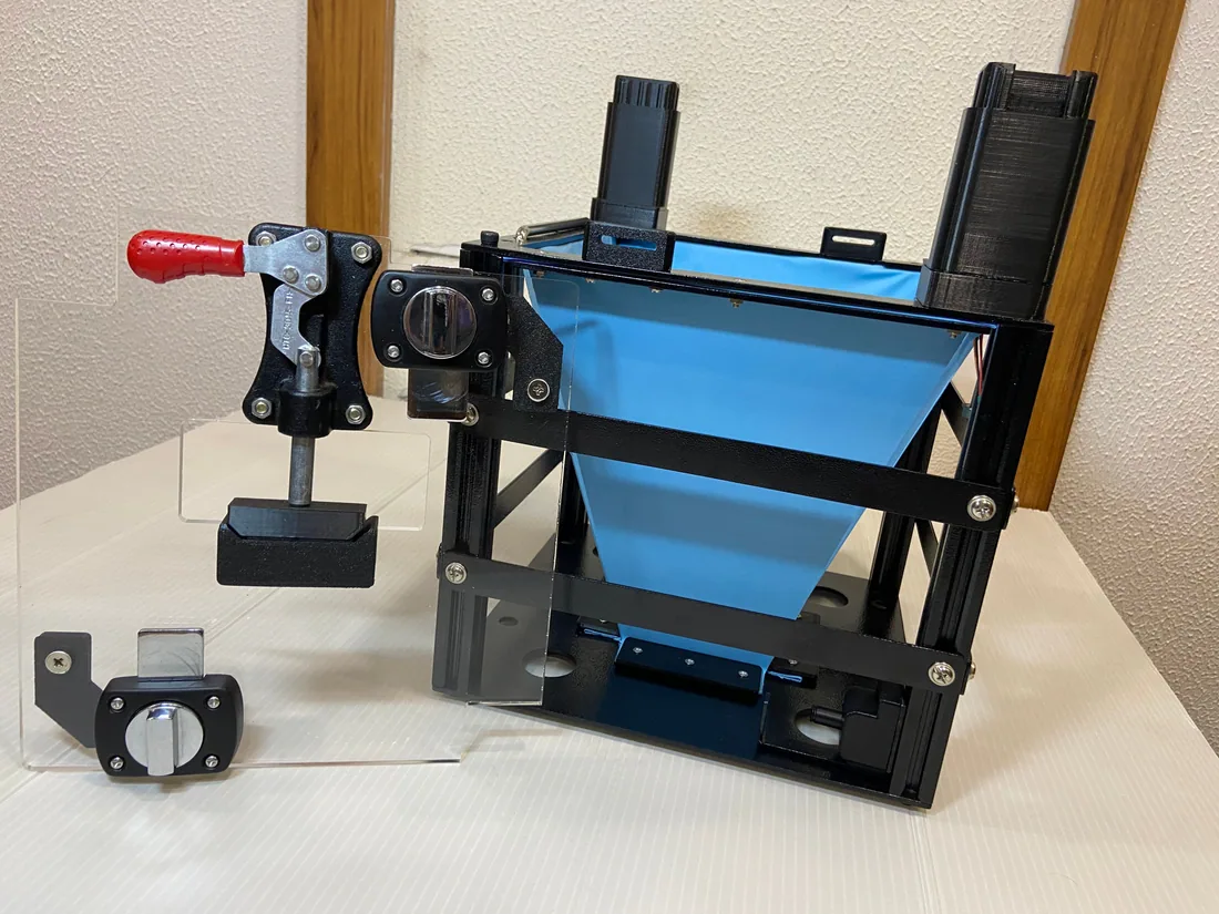 Side view of the latex membrane support frame with its latch and mounting hardware