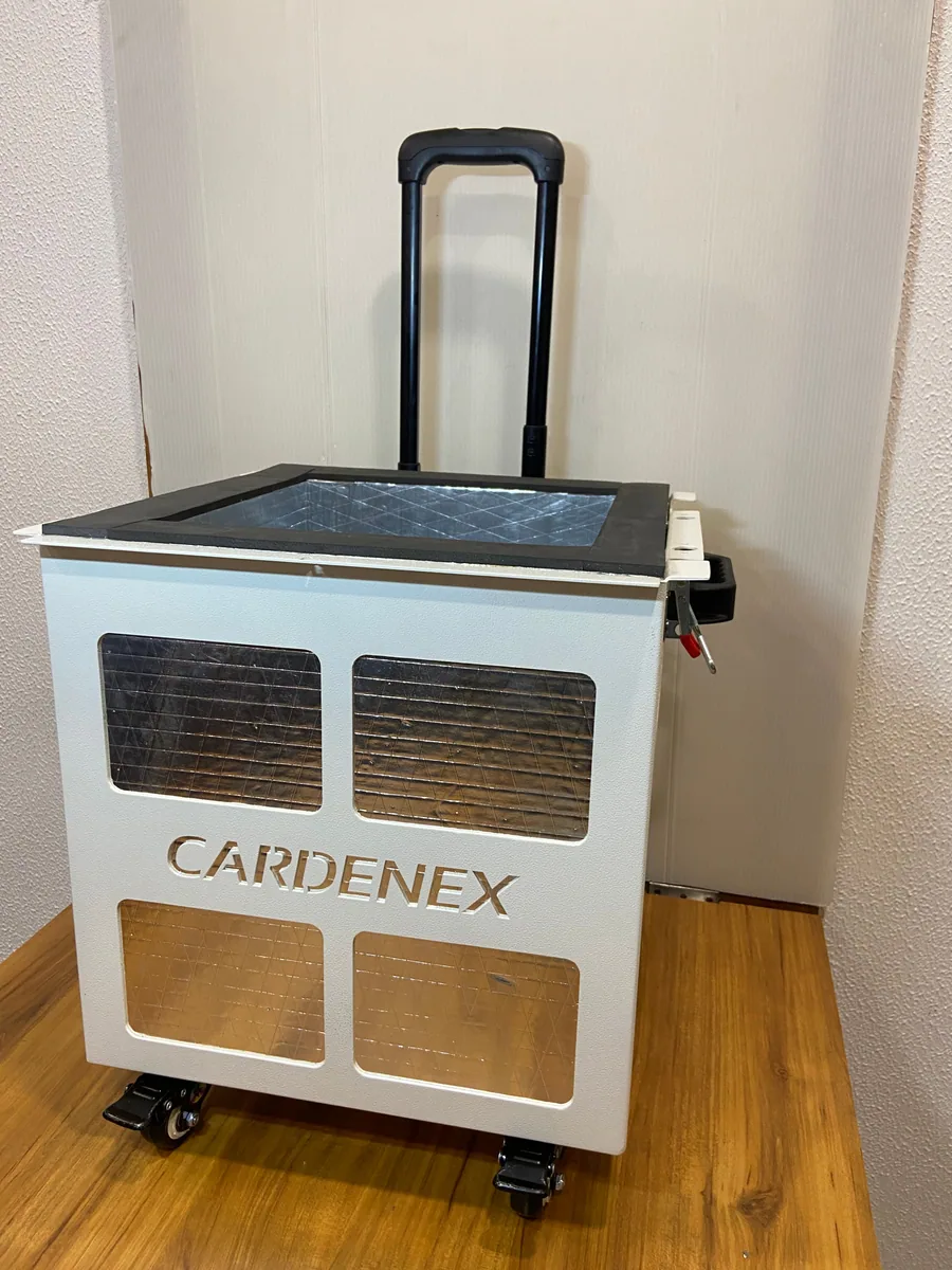 White suitcase-style organ transport box with a trolley handle and wheels