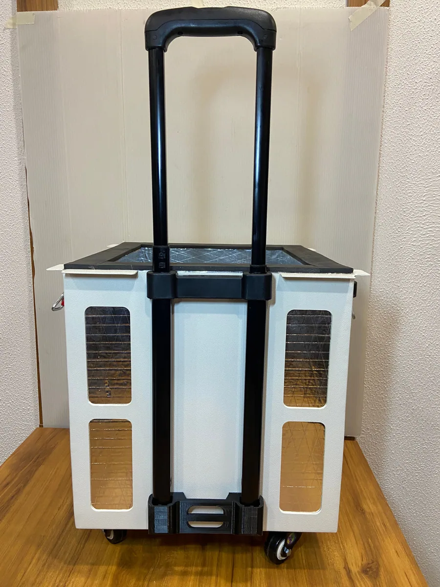 Back of the organ transport box with its extended trolley handle and wheels