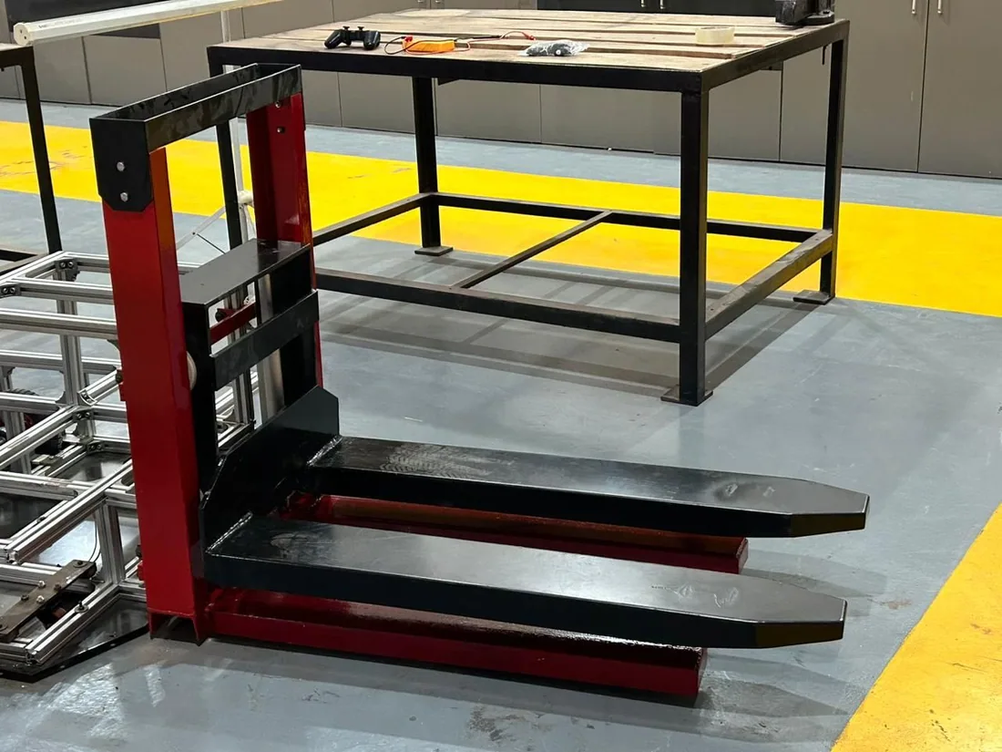 Red forklift mast and black forks of the autonomous forklift robot
