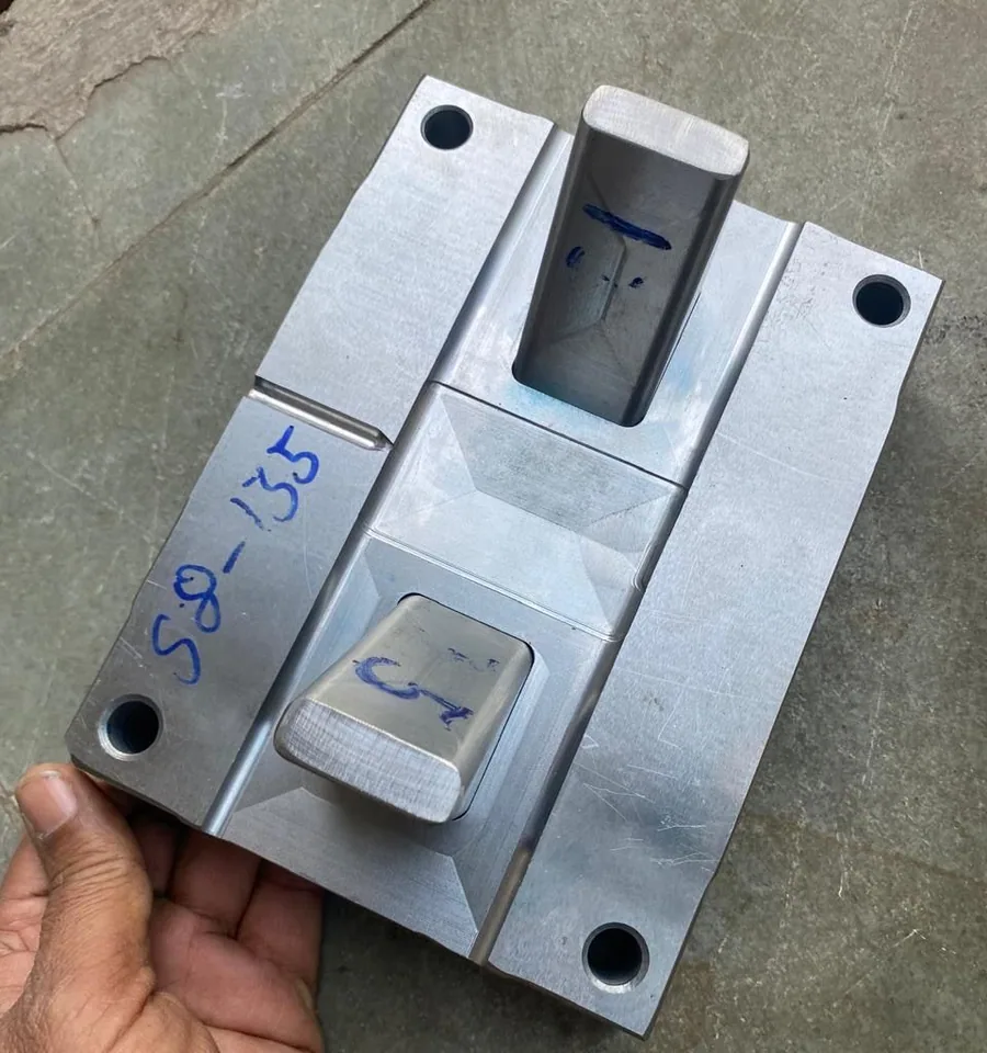 Machined injection mold half for the fitness cuff held in a hand