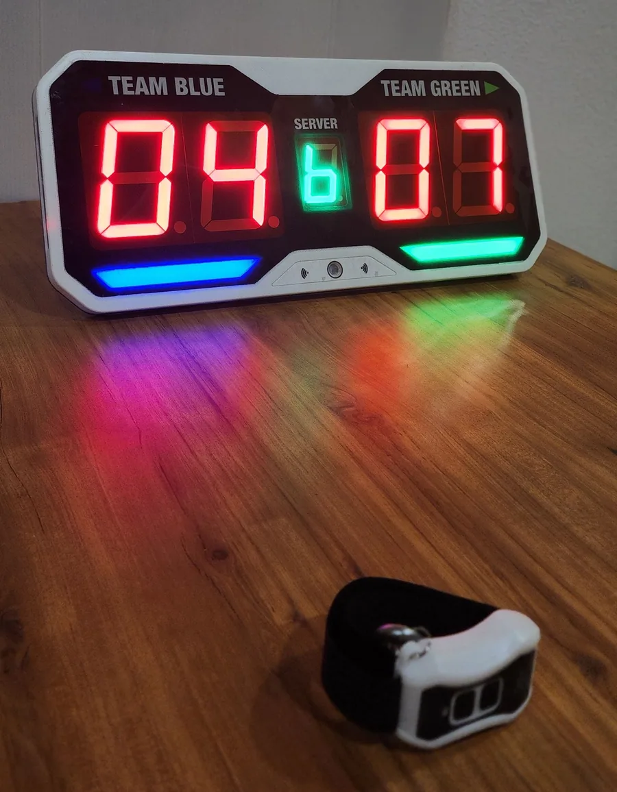 Pickleball scoreboard on a table with its wearable remote in the foreground