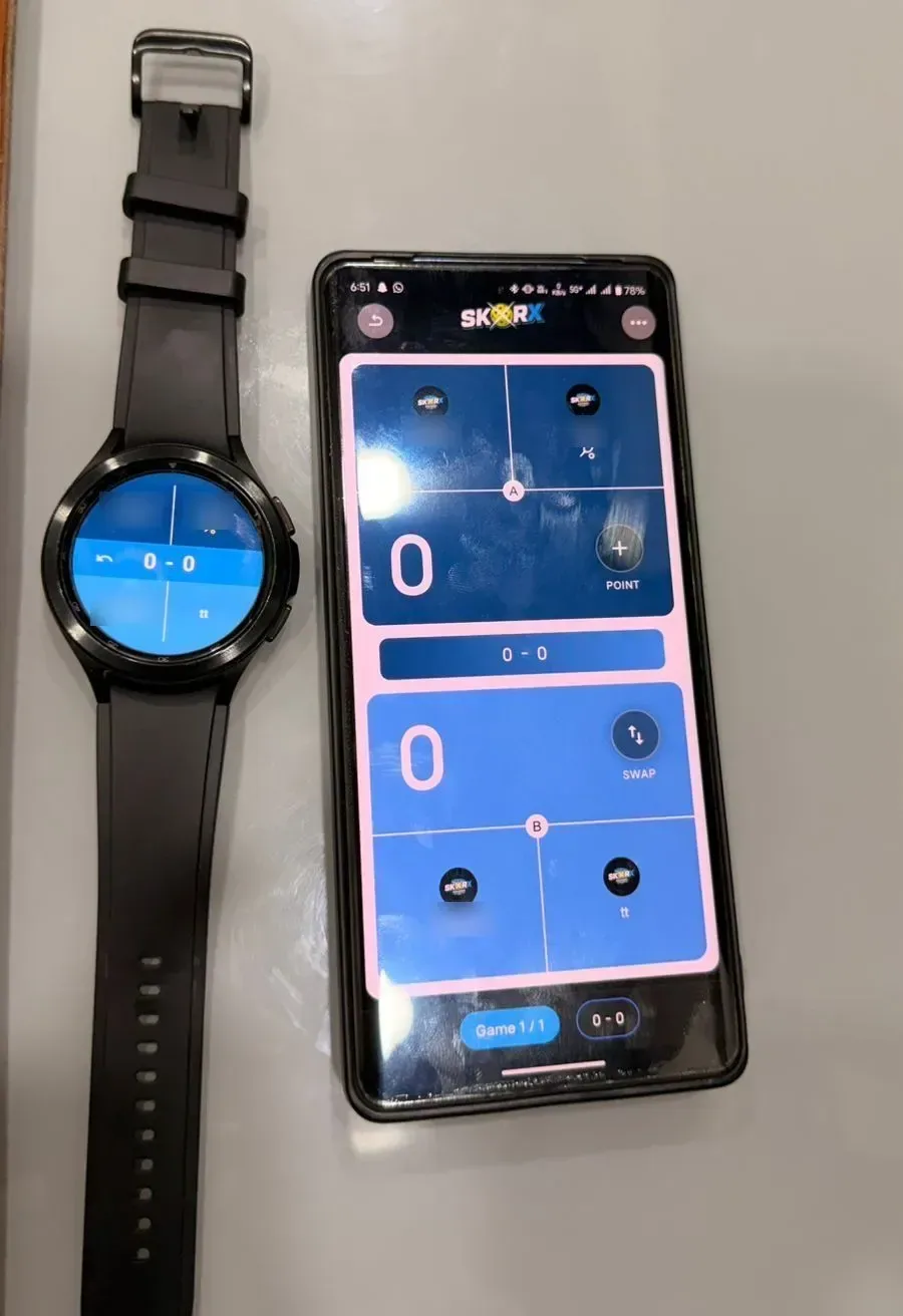 SkorX pickleball scoring running on a smartwatch beside a phone showing the same match score