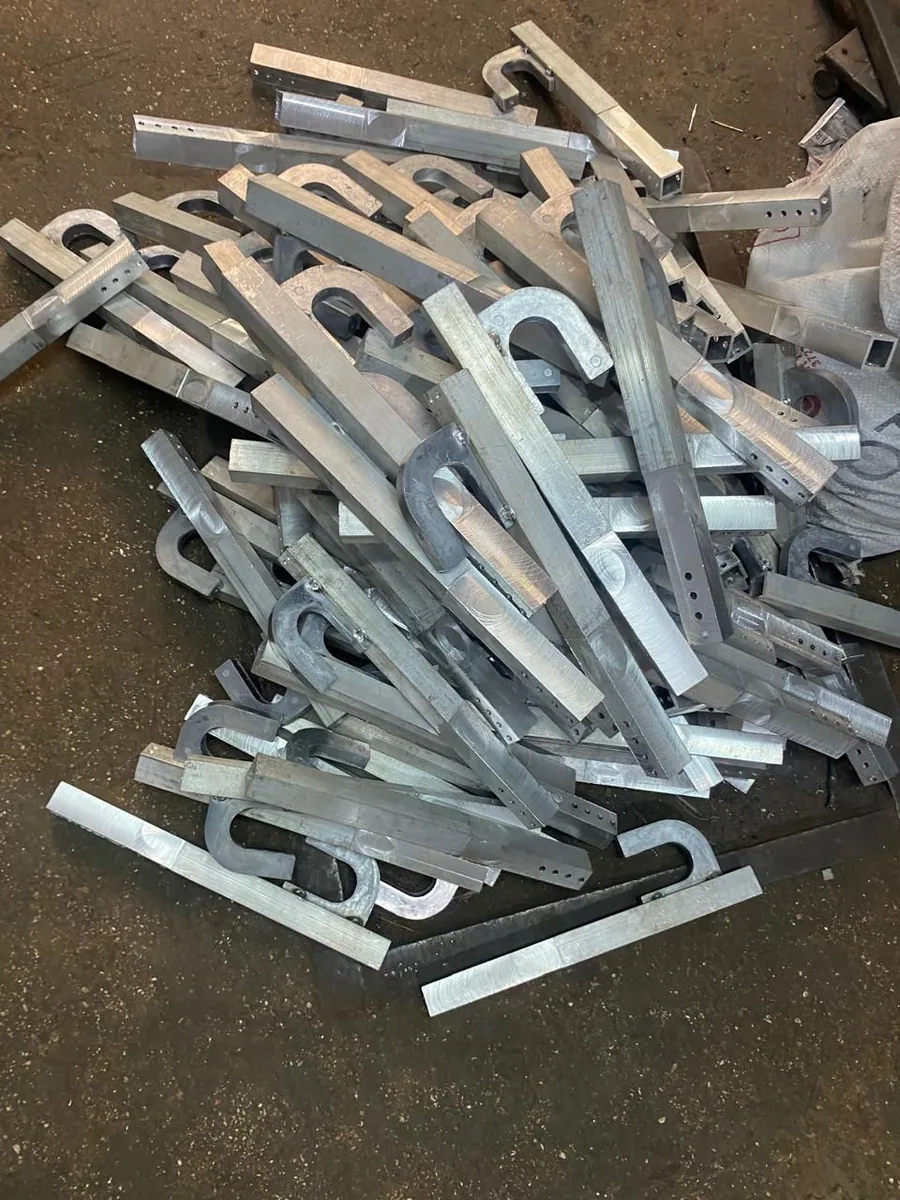 Pile of aluminum die-cast telescopic arms from a production run