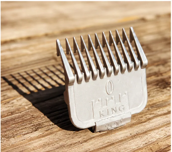 Grey prototype trimmer guard standing on a wooden surface