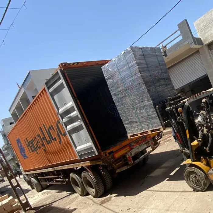 A forklift loading finished goods into a shipping container