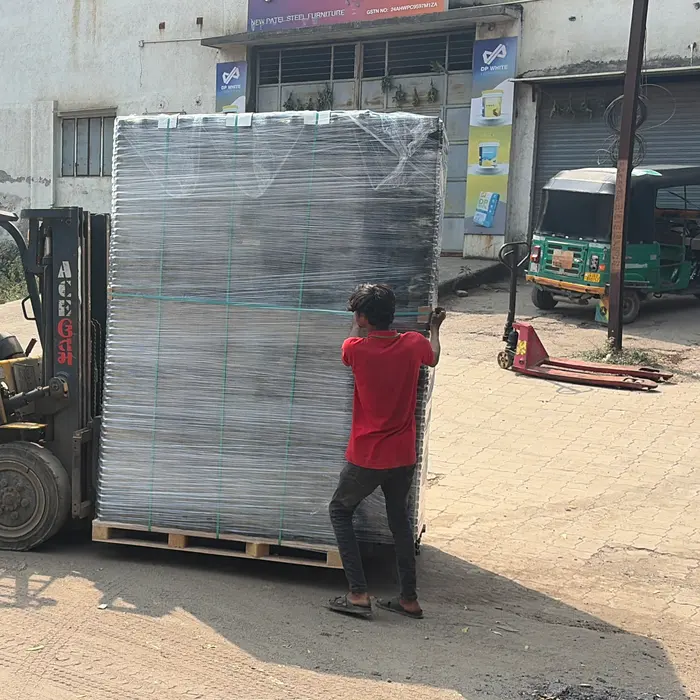 A forklift loading a wrapped shipment onto a truck