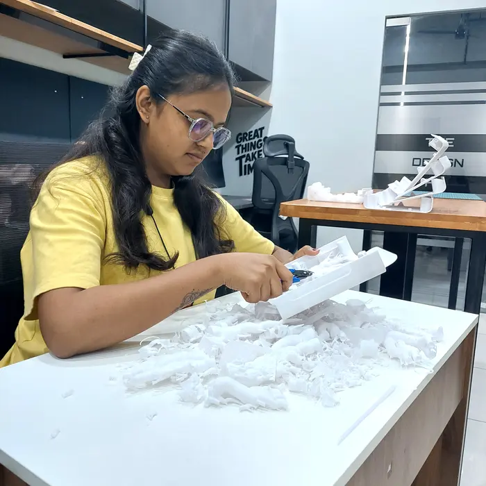 An engineer hand-finishing a physical prototype model