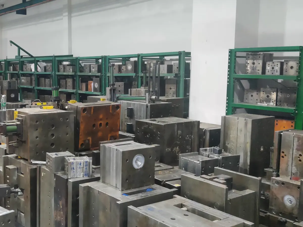 Steel injection molds stored on racks and on the tooling floor between production runs