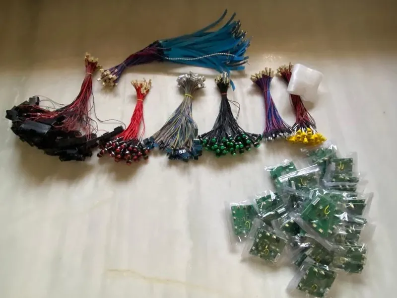 Batch of bagged LARP armor PCBs next to finished cable harnesses