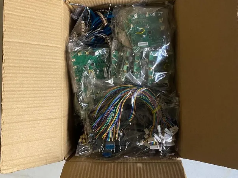 Tested LARP armor PCBs and cable harnesses, individually bagged in a shipping box