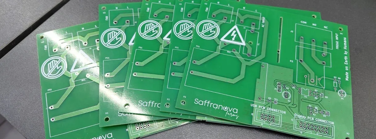 Bare Saffranova control PCBs fanned out on a table