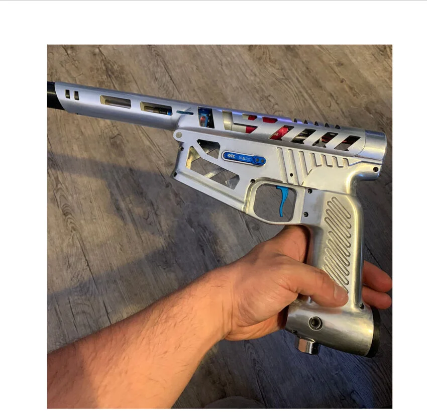CNC-machined aluminum airsoft gun housing next to a die-cast zinc part comparison
