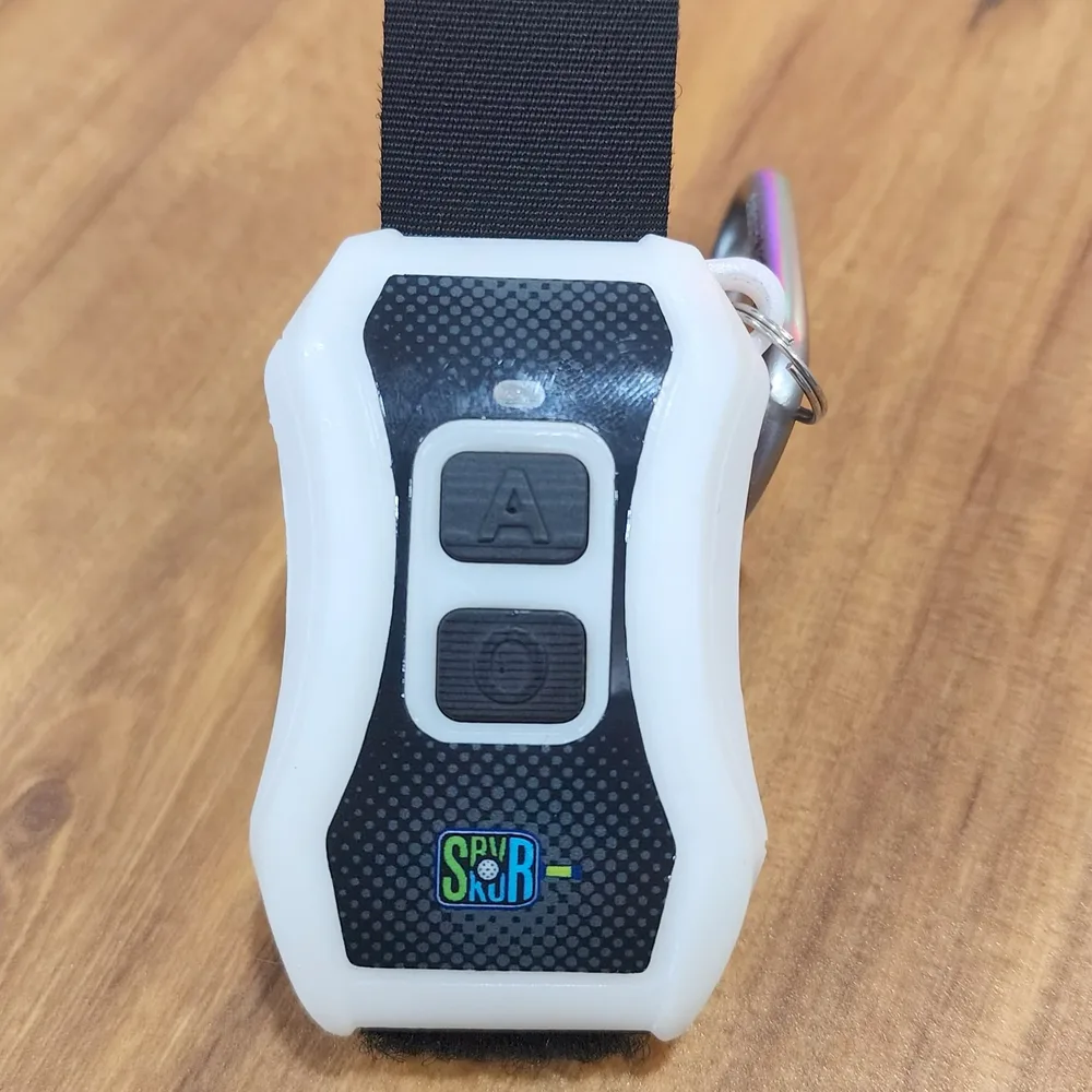 Close-up of the wearable wristband controller with two silicone buttons for wireless score updates